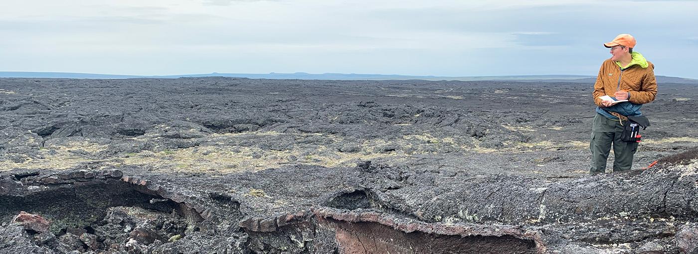 Erika Rader on a rocky landscape in Alaska.